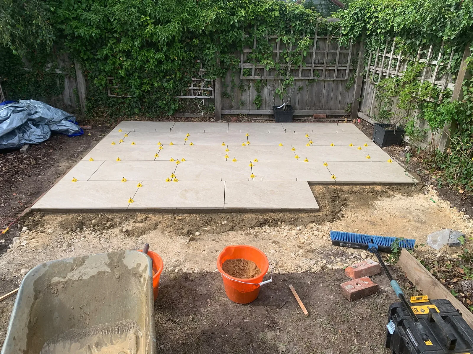 Patio slabs being laid on a prepared sub-base during installation – Fines Landscaping, West Norfolk