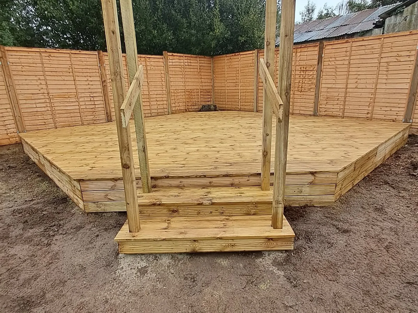 Raised softwood deck with steps and pergola posts – Fines Landscaping, West Norfolk