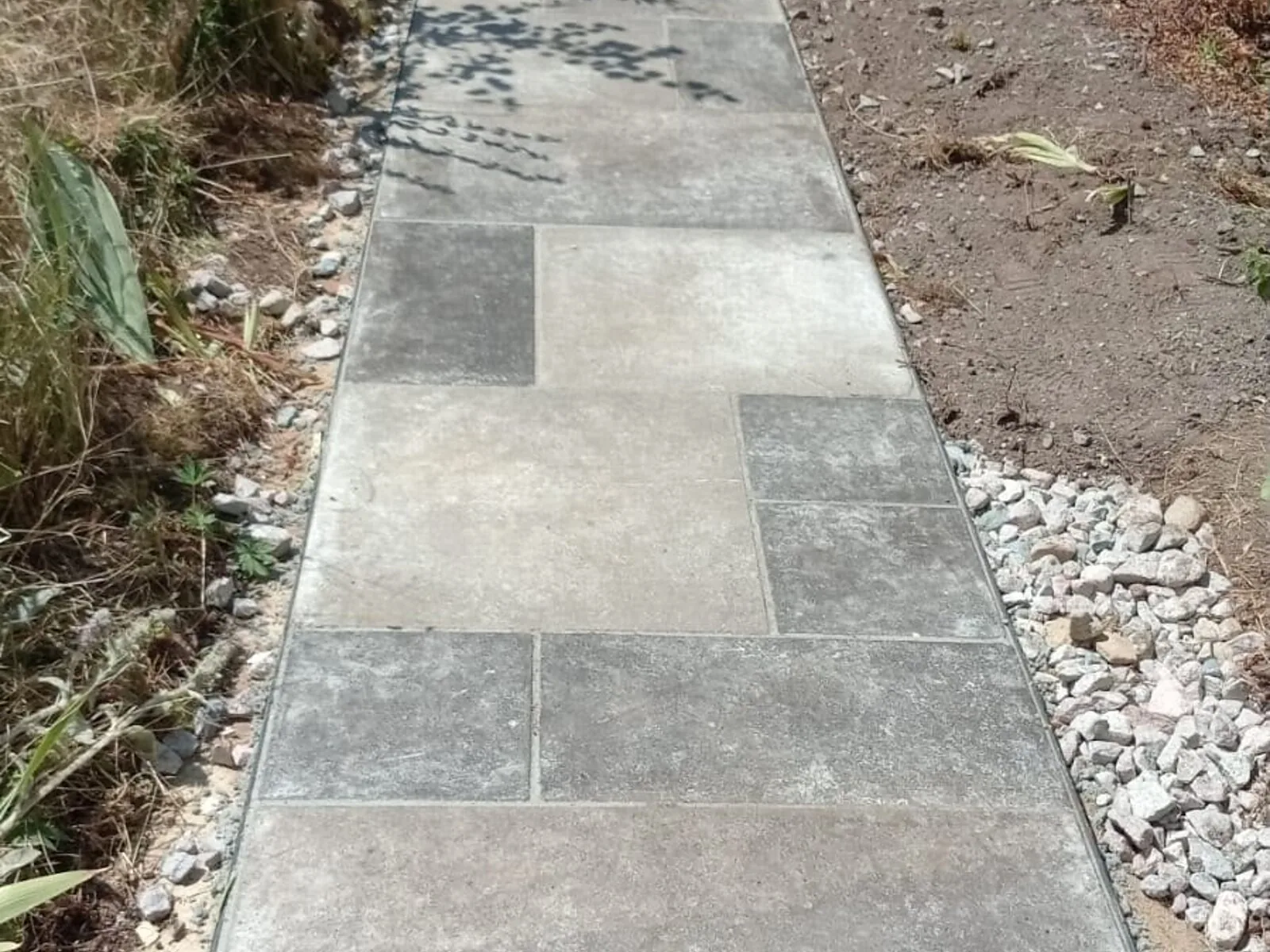 New grey slab garden path laid along a side passage – Fines Landscaping, West Norfolk