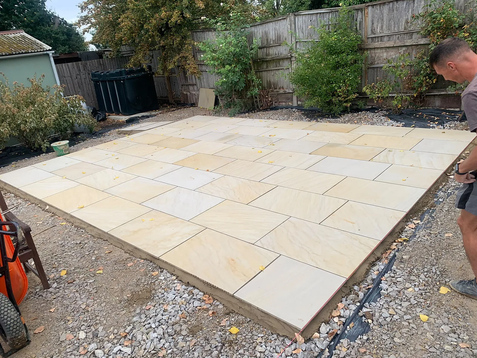 Patio installation in progress with slabs laid on mortar bed – Fines Landscaping, West Norfolk