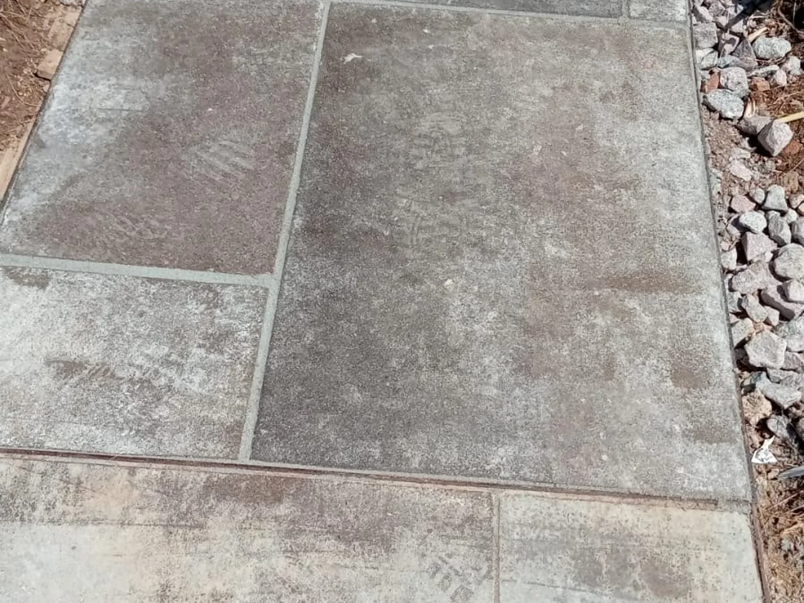 Large grey paving slab path to a garden door – Fines Landscaping, West Norfolk