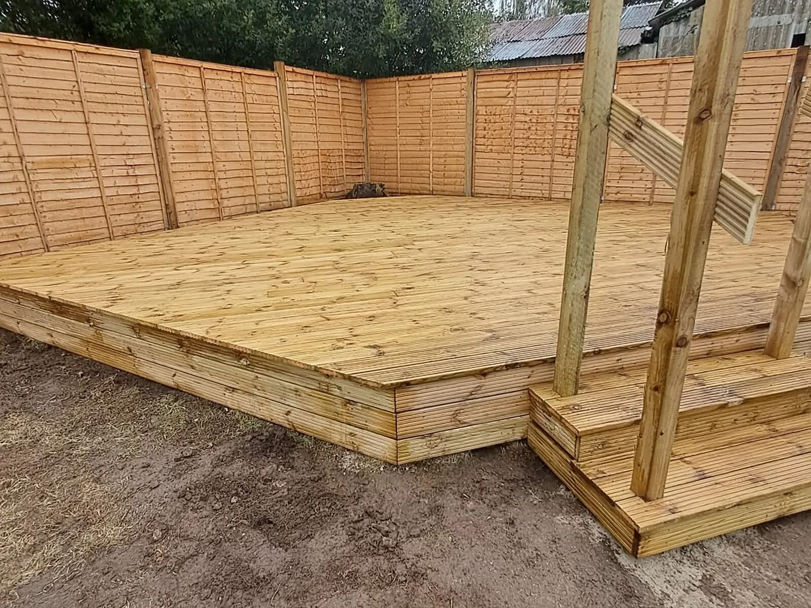 Corner timber deck with steps and pergola posts – Fines Landscaping, West Norfolk