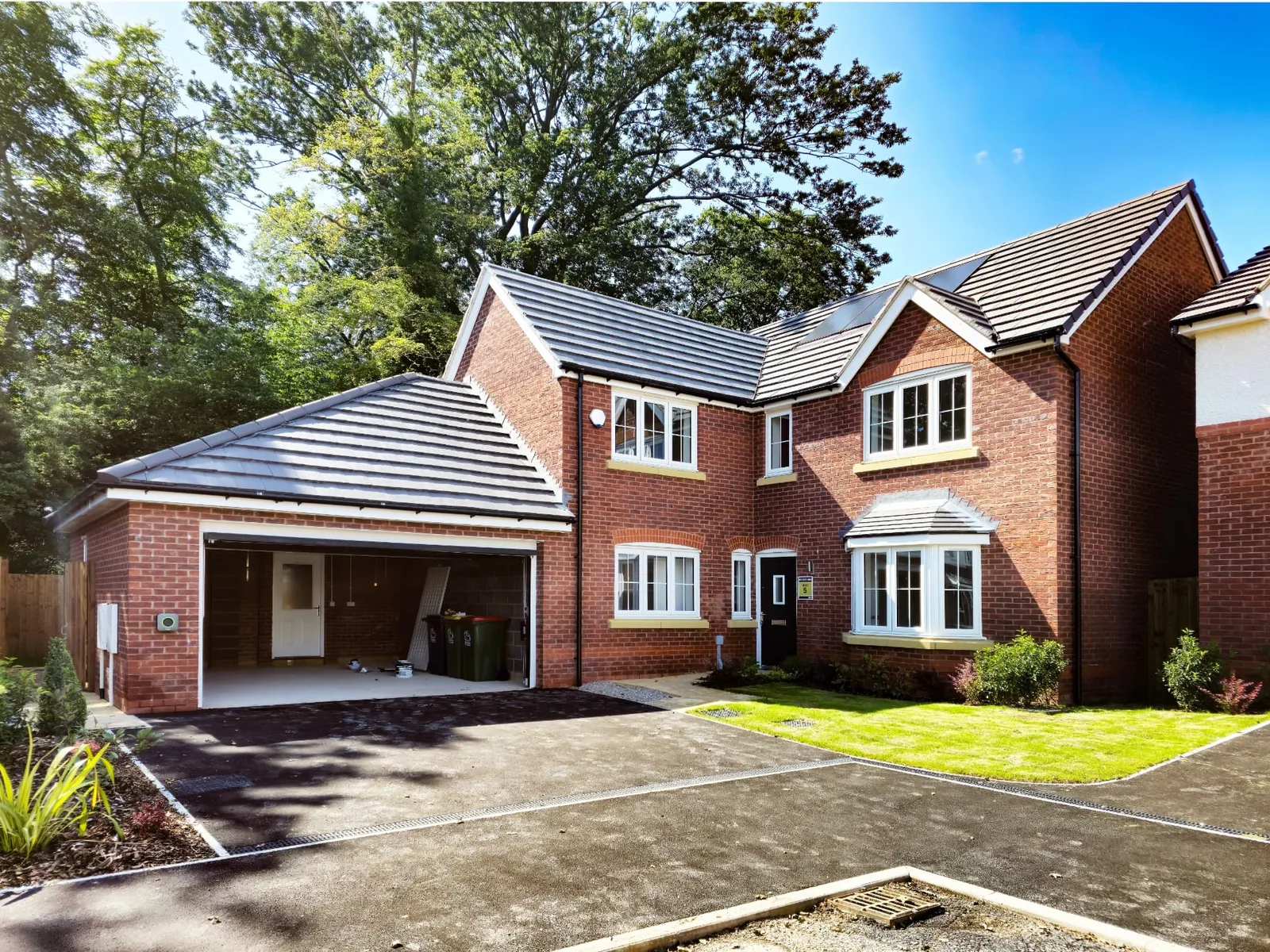 Tarmac driveway in front of a brick house – driveways by Fines Landscaping, King's Lynn