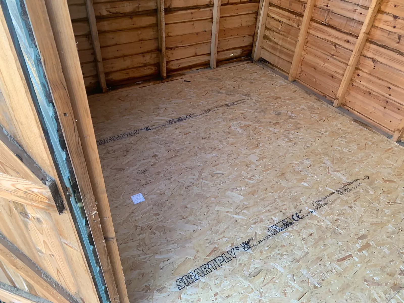New OSB floor fitted inside a timber shed – Fines Landscaping, West Norfolk