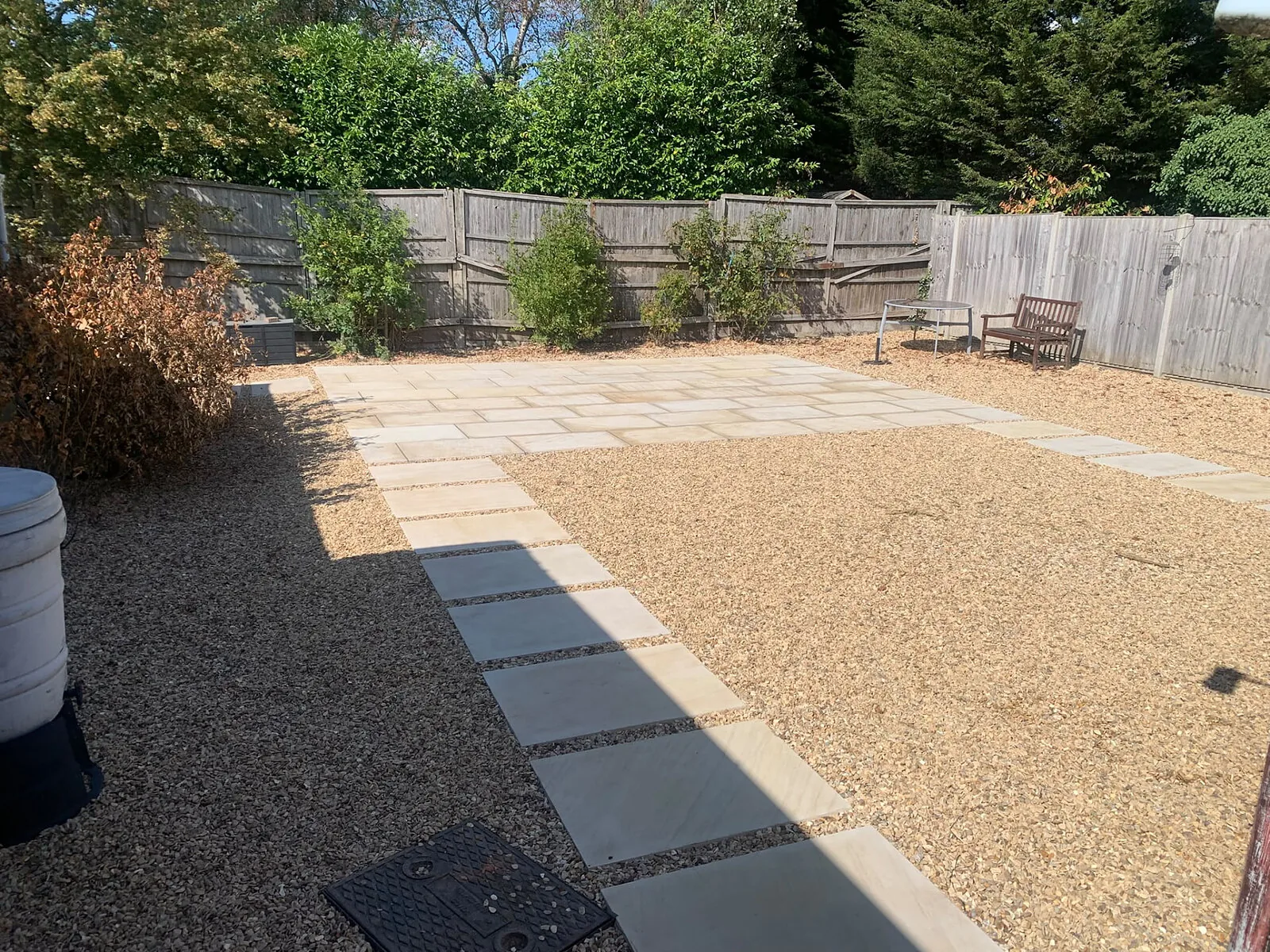 Buff paving patio with gravel surround and slab stepping path, King's Lynn area