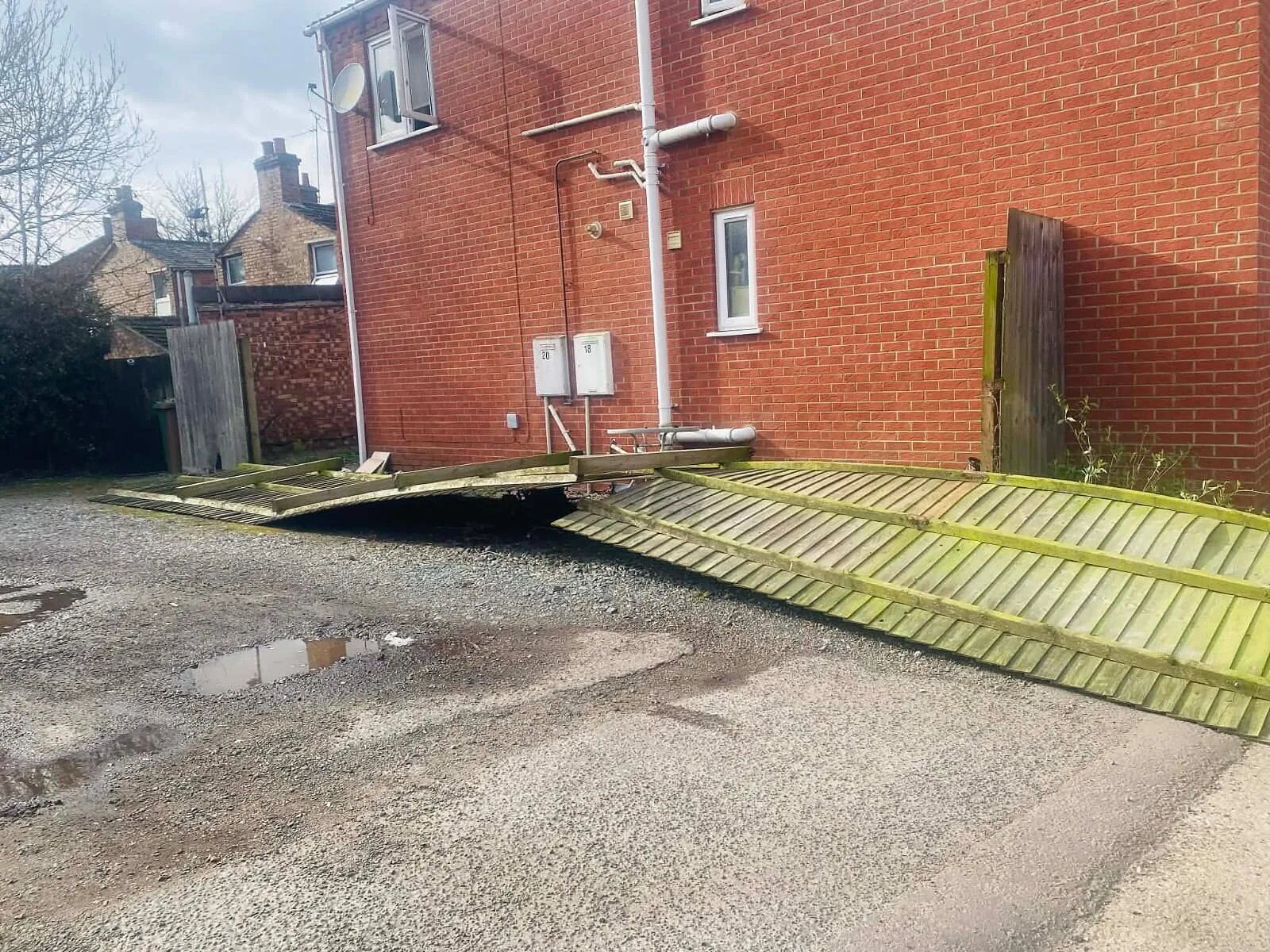 Storm-damaged fence lying flat before new fencing was fitted – Fines Landscaping, West Norfolk